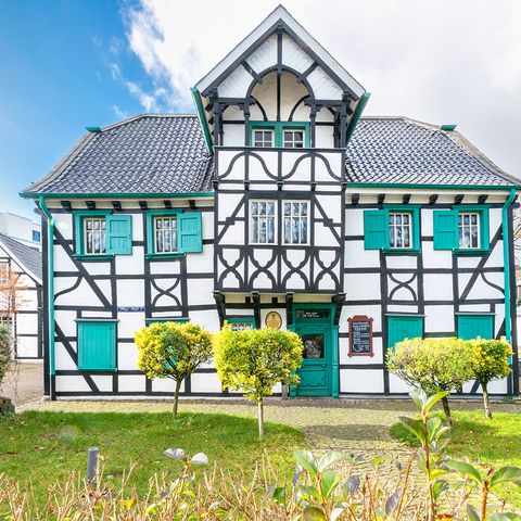 Half-timbered building Haus Arndt in Langenfeld with green shutters